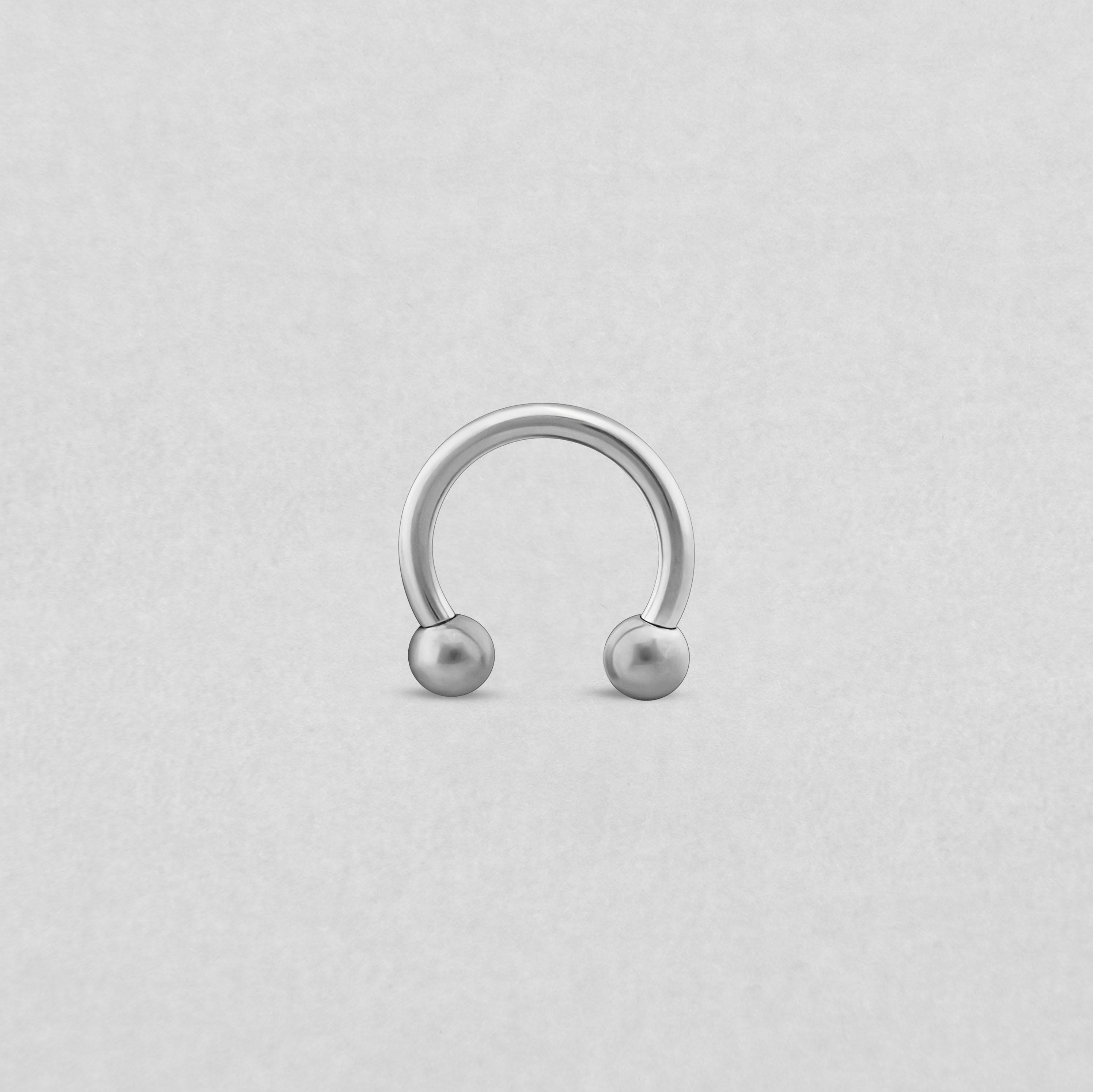 Se muestra una barra circular de NOBLE ART BEAUTY SOCIEDAD LIMITADA con dos extremos redondos sobre un fondo liso de color gris claro.