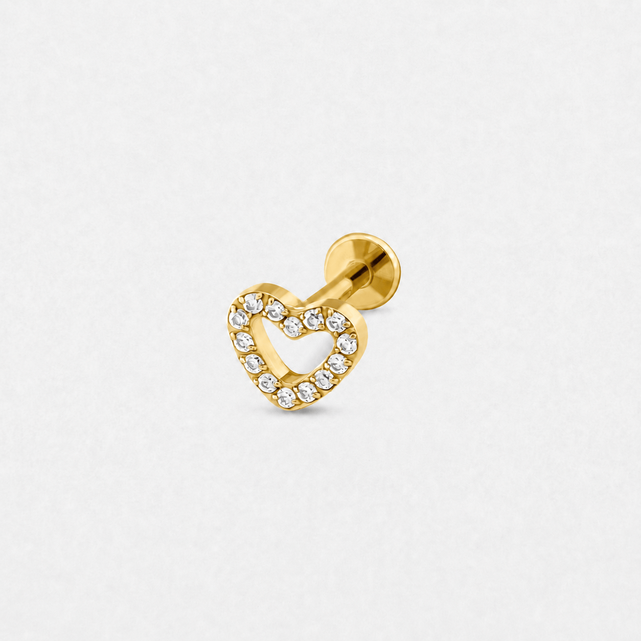 Los pendientes de botón «Love liso gold heart» de Titanio-Noble Art presentan el contorno de una piedra preciosa sobre un fondo blanco: un elegante accesorio inspirado en la artesanía de Noble Art.