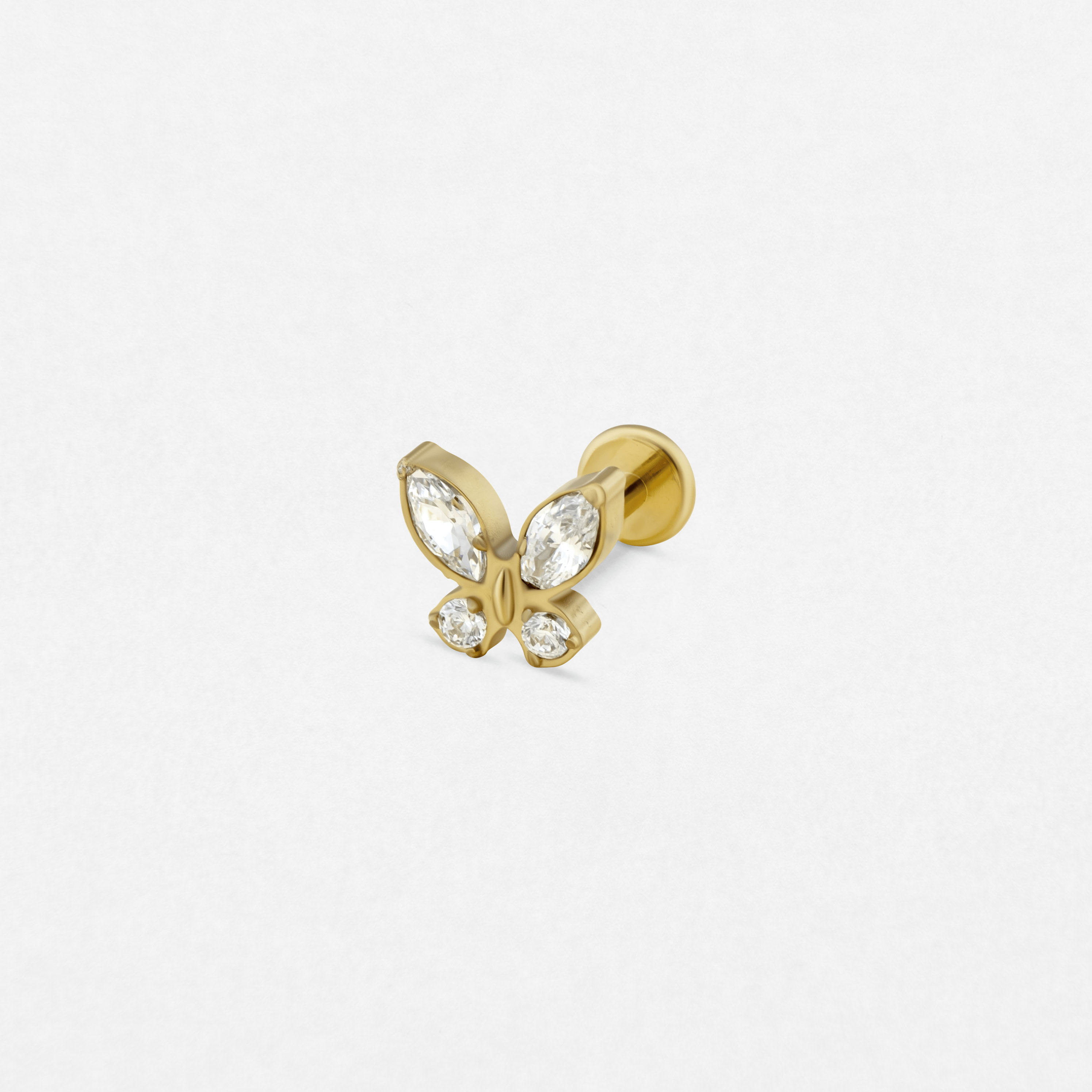 El pendiente de oro «Butterfly» de la colección Titanio-Noble Art cuenta con cuatro piedras preciosas transparentes, en forma de marquesa y redonda, dispuestas en forma de mariposa sobre un fondo blanco, lo que lo convierte en la pieza ideal para realzar tu colección de pendientes.