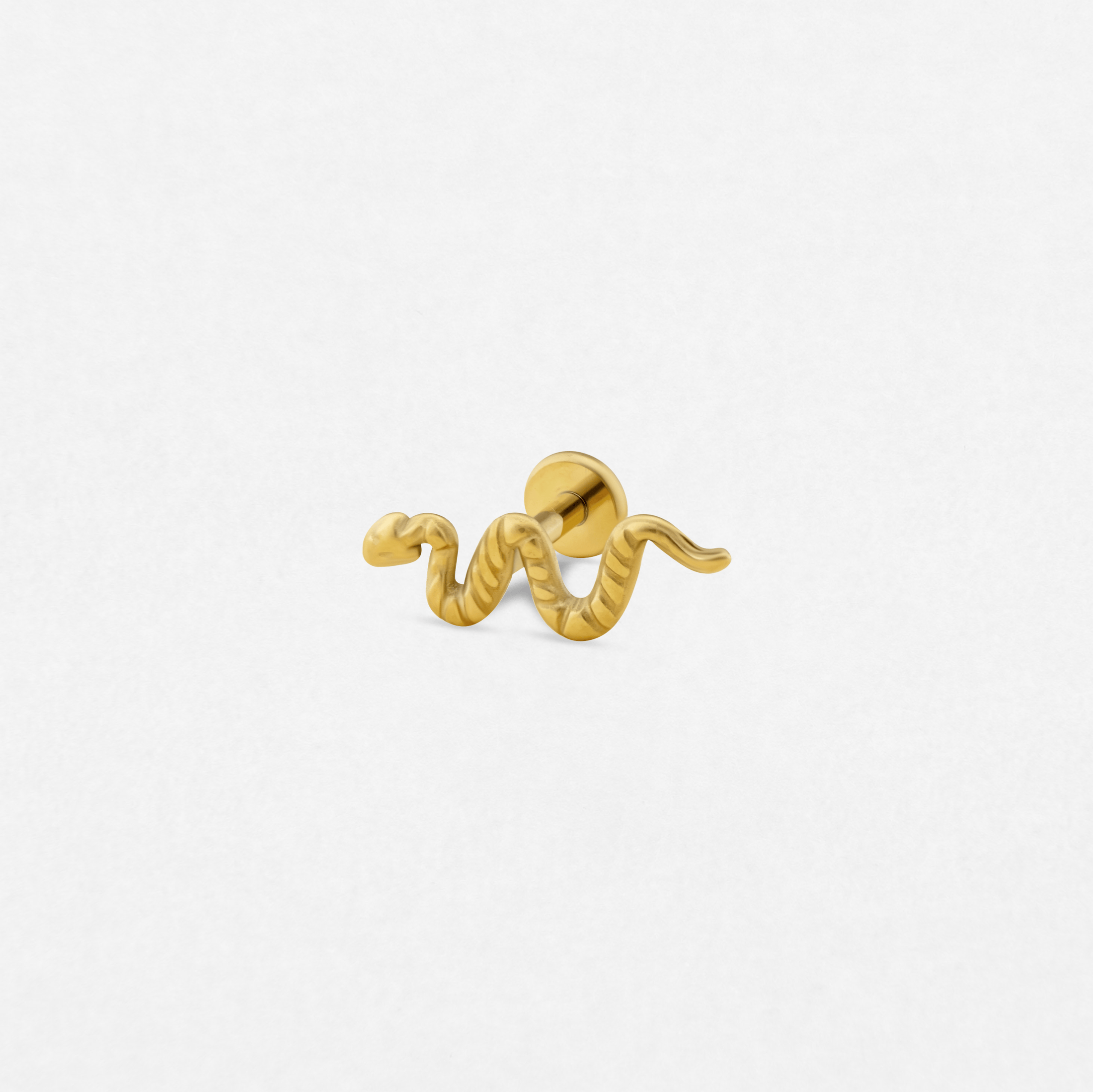 El pendiente tipo «ear cuff» Snake Gold de Titanio-Noble Art presenta un diseño de serpiente enroscada, tan intrincado como un tatuaje, y se muestra sobre un fondo blanco liso.